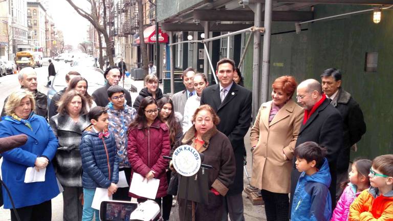 State Senator Liz Krueger (first row, center, speaking) and City Council Member Ben Kallos (standing behind her, second row center) at a press conference in March announcing new supportive housing for families on East 91st Street between First and Second Avenues. The two East Side elected officials hold different views about whether residents should give money to homeless panhandlers or offer help in other ways or both. Photo: Courtesy of Senator Liz Krueger's office