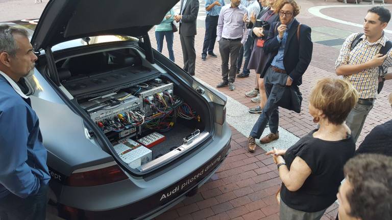 A self-driving Audi A7 on display outside the David N. Dinkins Municipal Building earlier this week attracted passers-by, who gazed at the tangle of electrical wires in its trunk. Photo: Micah Danney
