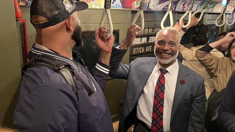 NYC Transit President Demetrius Crichlow was snapped aboard the NYY Opener Low-V train to Yankee Stadium; some Yankee notables also rode along. Straus News Manhattan queried Crichlow if he was the Yankees opening pitcher that day. His answer? “No, not today.”