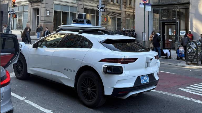 A Waymo robotaxi at Broadway and Walker Street, March 2026.