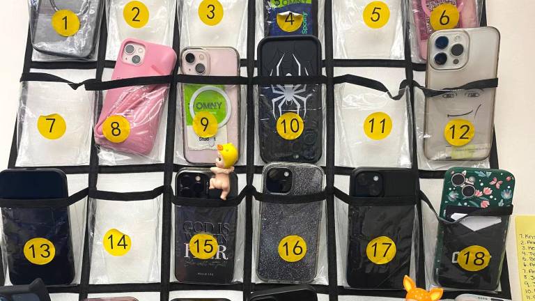 Students in a statistics class at New Heights Academy Charter School in Manhattan’s Harlem store their phones in pouches at the back of the classroom on Tuesday, May 6, 2025. A statewide cellphone ban will take effect this fall.