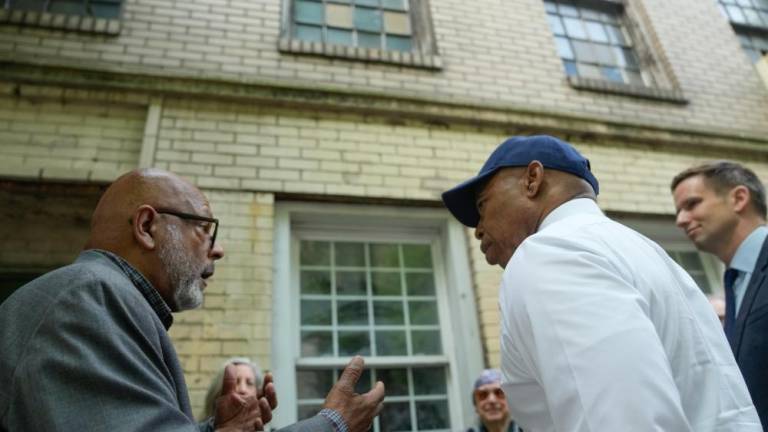 Author and activist Eric K. Washington (far left), celebrates with New York City Mayor Eric Adams (center) and Council Member Eric Bottcher (far right) on a visit to former Colored School #4 in Chelsea on Tuesday, May 23, following its approval as an official city landmark. Photo: Michael Appleton/Mayoral Photography Office