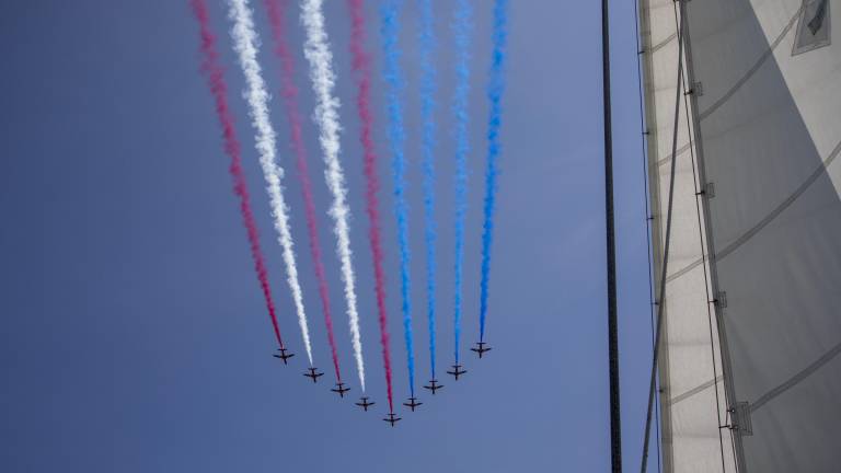 BAE Hawk jets flying over the Hudson River and leaving red, white, and blue vapor trails in the shape of the U.S. flag as part of the Sail4th 250 celebrations.