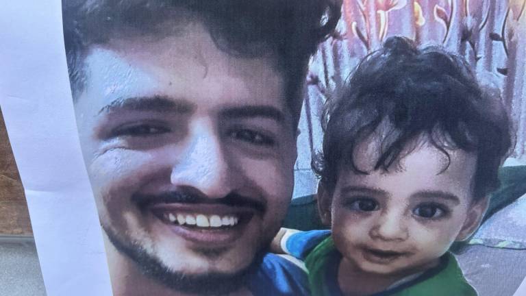A photo of victim Abdul Saleh and his young son was taped to the RIP sign outside Sal’s Deli on E. 13th St. and Ave. B. He also had a young daughter.