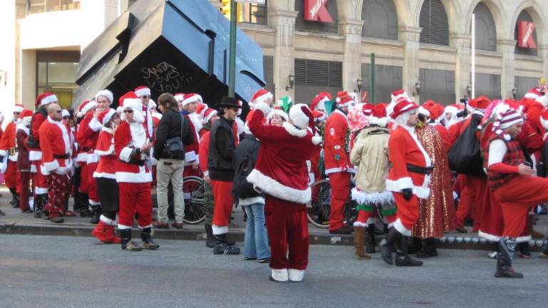 Santas convening around the Astor Place Cube during 2007’s SantaCon. They scribbled pronouncements such as “Santa Loves You!!” on the side of the famous spinning monument.