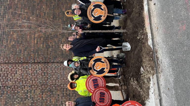 City Council Member Erik Bottcher (center) poses with a sapling, the 1,000th he’s planted locally during his time representing Chelsea and Hell’s Kitchen. He was joined by local laborers, allies, and Parks Department reps.