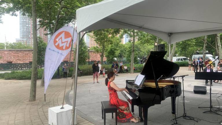 Mina Kim, conductor of the Purchase Symphony Orchestra, was one of two pianists for the starting event of the day at Battery Park. Photo: Ralph Spielman