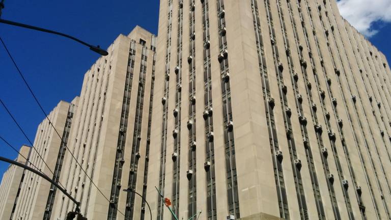 The suspect was being held at 100 Centre St. when he experienced a medical emergency and died.