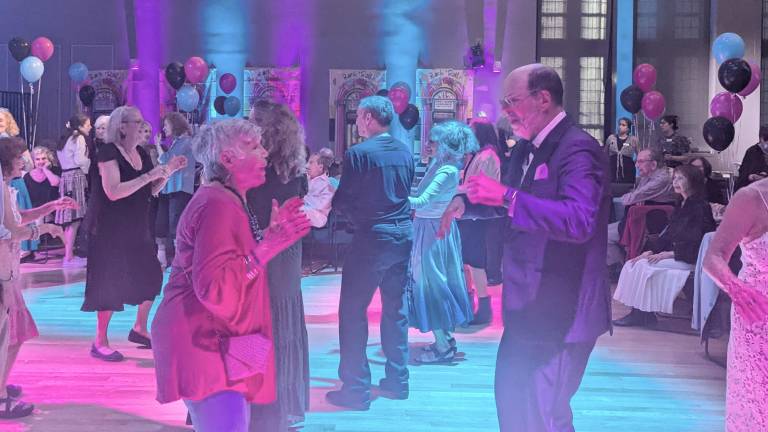 Himan Brown Director David Knapp dances with member at the 75th anniversary of Himan Brown program at 92Y for New Yorkers in the 60+ age set.