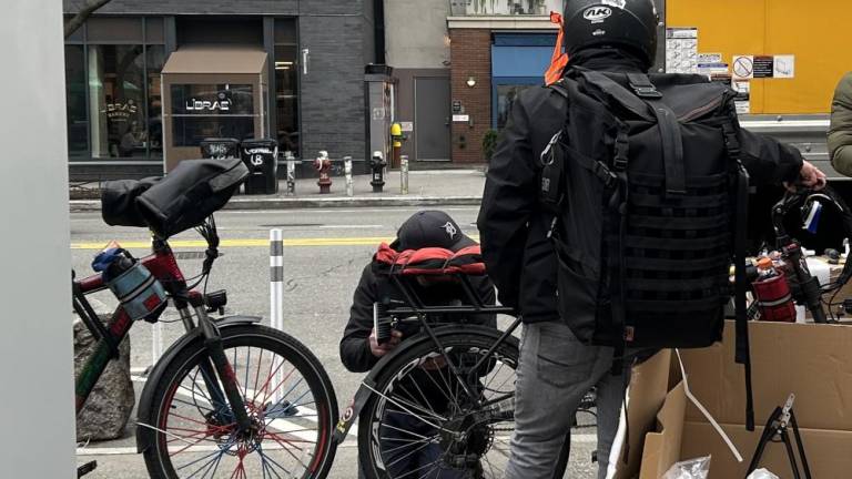 A delivery worker who just registered to the pilot program and is getting his battery installed by Swobbee on March 7 at Cooper Square in the East Village. Photo Credit: Alessia Girardin.
