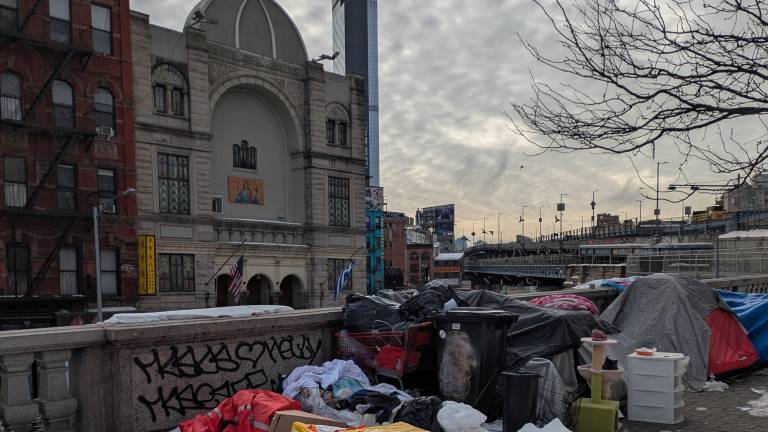 Even in arctic cold, some homeless remained in downtown shantytown, Feb. 6, 2026, with St. Barbara Greek Orthodox Church in the background.