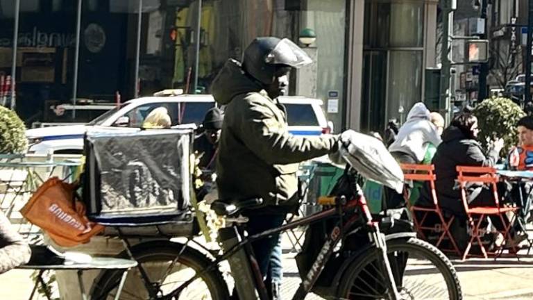 A delivery driver on his e-bike run by lithium batteries in Herald Square between 6th avenue and 35th street may soon be able to get a free charge under a new six month pilot program. Photo Credit: Alessia Girardin.