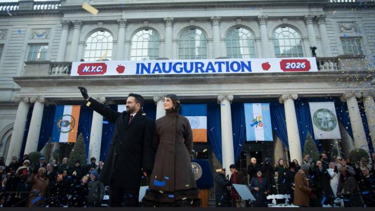 Mayor Zohran Mamdani waves to supporters at his swearing-in ceremony at City Hall on Jan. 1. He was accompanied by his wife, Rama Duwaji, who held the Quran as he was sworn in as the first ever Muslim mayor.