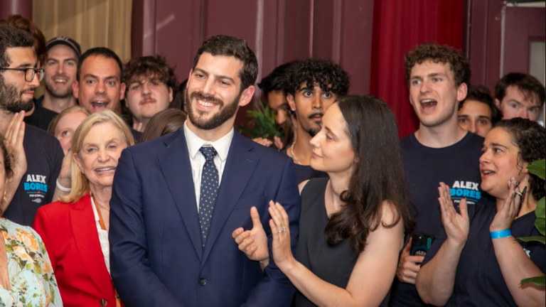 Alex Bores (center), wife Darya (right) and and many supporters on primary night June 23.